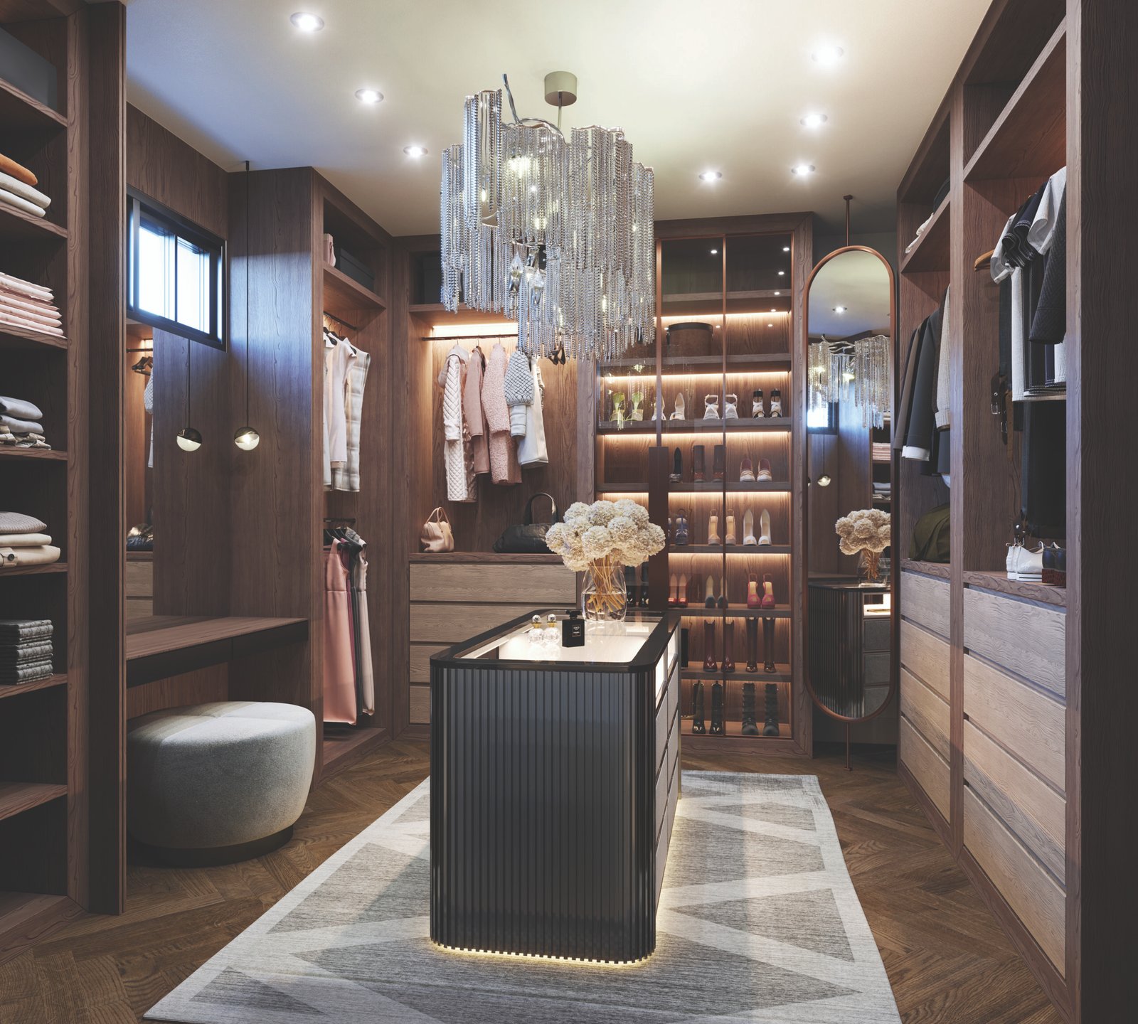 A luxurious walk-in closet with wooden shelves filled with clothes and shoes, perfect for new homes. A central island is adorned with decorative flowers under a glamorous crystal chandelier. Soft lighting creates a warm ambiance, highlighting elegant décor and design.