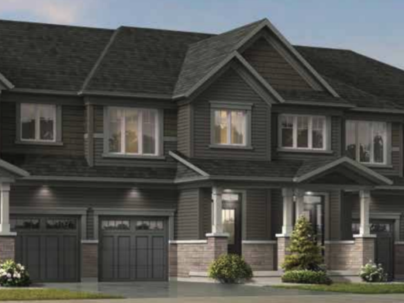 A modern townhouse complex in Brampton with four connected units, each boasting a garage, a front porch, and multiple windows. The exterior showcases a gray and stone color scheme with small shrubs and trees in front. The clear sky suggests it's a sunny day—ideal for new home seekers.
