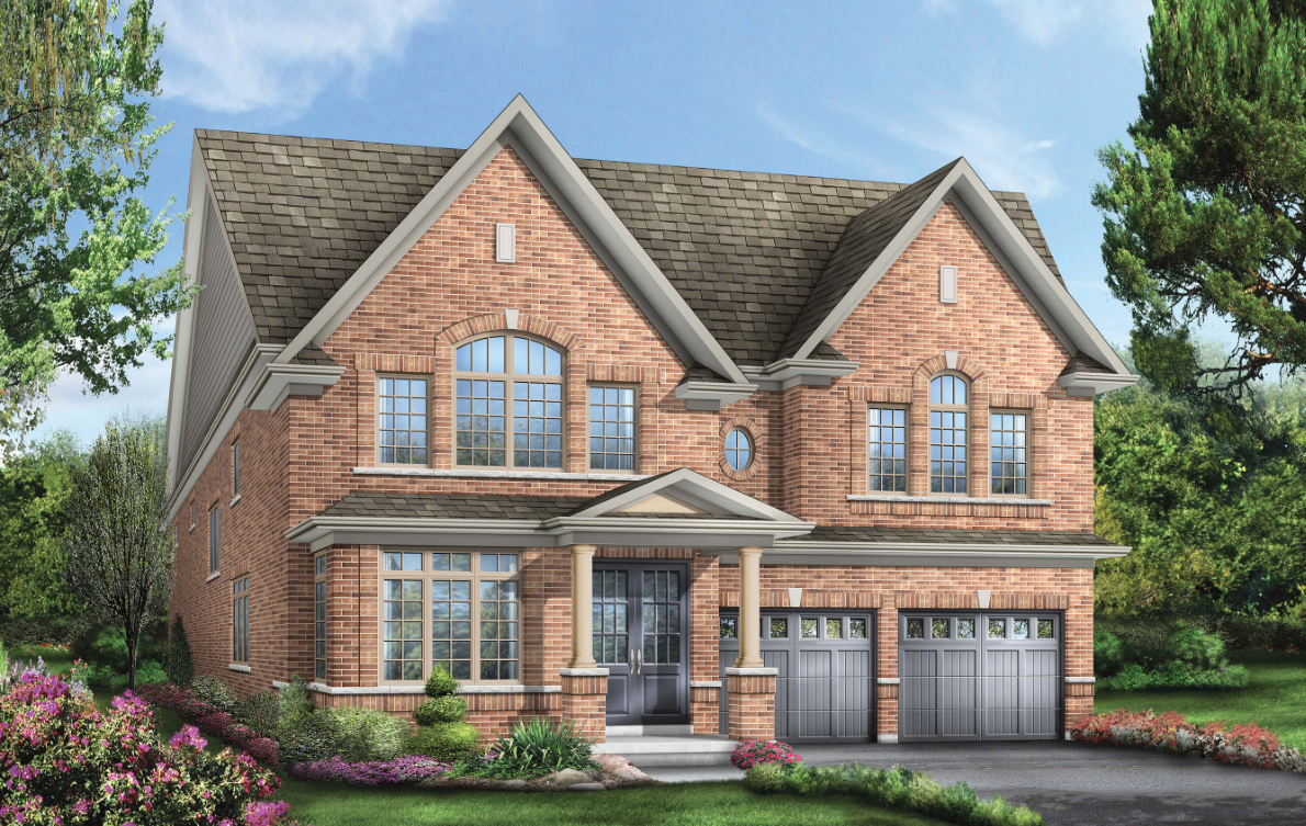 This large two-story brick house boasts a gabled roof, multiple windows, and two garage doors. The front yard is adorned with manicured shrubs and colorful flowers on a well-maintained lawn beneath the clear blue sky—a prime example of new homes in Brampton.