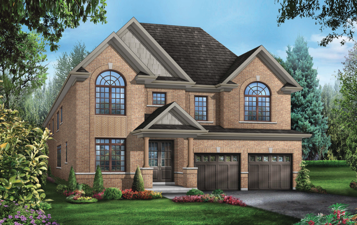 A two-story brick house with large arched windows, a dark shingled roof, and two garage doors. This pre-construction home is surrounded by a well-maintained garden with shrubs and colorful flowers, set against a backdrop of trees and blue sky.