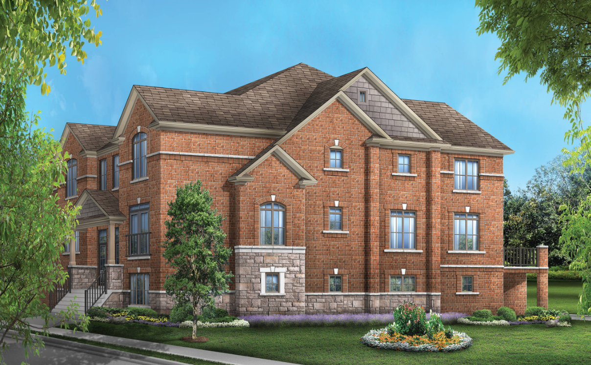 A spacious two-story brick house with multiple gables and windows stands against a blue sky. The front yard showcases well-maintained greenery and a flower bed, while trees frame the scene. Ideal for those exploring new homes, this property exudes charm and comfort.