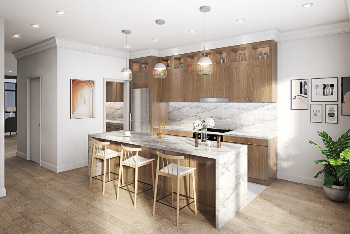 A modern kitchen in new condos in GTA features wooden cabinets and marble countertops. Three pendant lights hang above a large island with seating for three. Stainless steel appliances and framed artwork adorn the walls, while a potted plant sits in the corner.