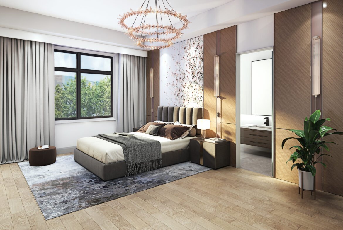 A spacious bedroom with a modern design features a large bed, patterned rug, and leafy plant. Neutral-colored walls complement the large window with curtains, while a contemporary chandelier adds elegance. An open door reveals a glimpse of the bathroom. Ideal for those seeking new homes in GTA.