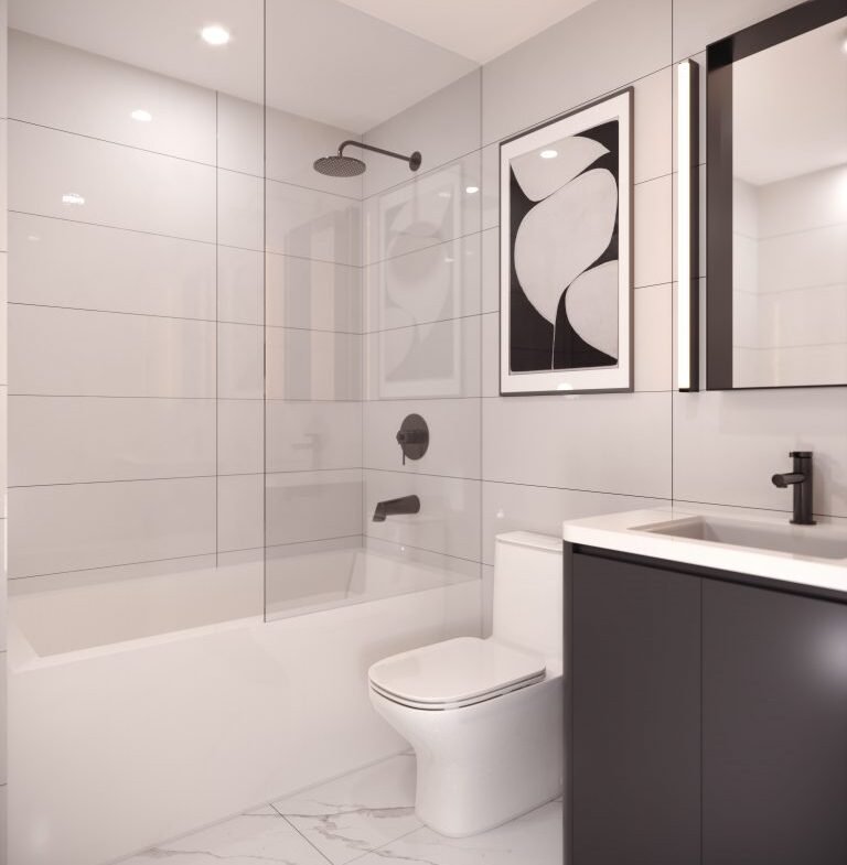 The Park Place VMC-inspired minimalist bathroom features a shower, bathtub, modern vanity with a black faucet, and toilet. Large gray tiles line the walls with a black and white abstract art piece above the toilet. The floor showcases sleek white tiles.