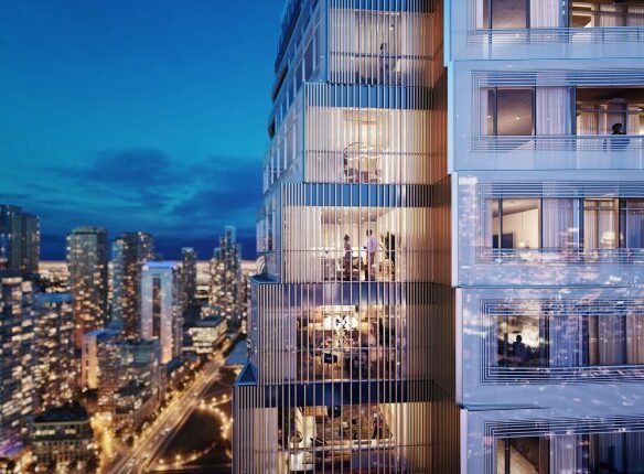A modern high-rise building at night, its illuminated windows revealing activity inside. VMC condos stand tall against the city skyline, with Park Place nestled nearby. A river shimmers in the background under a twilight sky, creating a vibrant urban scene.