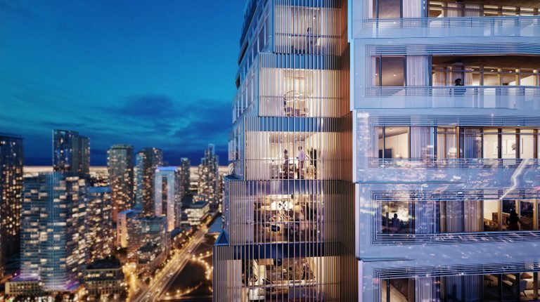 A modern high-rise building at night, its illuminated windows revealing activity inside. VMC condos stand tall against the city skyline, with Park Place nestled nearby. A river shimmers in the background under a twilight sky, creating a vibrant urban scene.