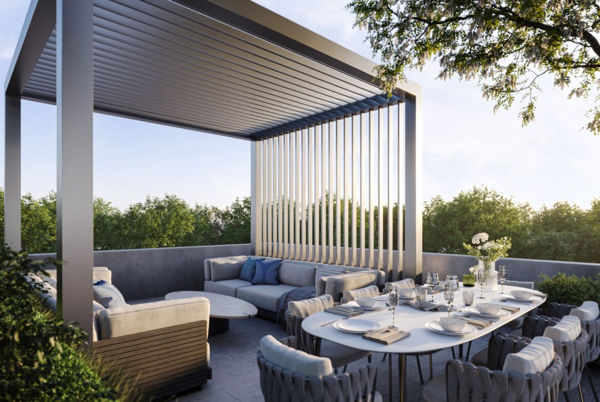 A modern outdoor patio at Mile & Creek Condos features a sleek pergola, a comfortable seating area with cushions, and a dining table set for six. Surrounded by lush greenery, the serene scene is beautifully illuminated under a clear sky.