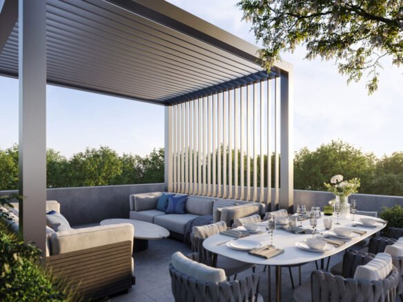 A modern outdoor patio at Mile & Creek Condos features a sleek pergola, a comfortable seating area with cushions, and a dining table set for six. Surrounded by lush greenery, the serene scene is beautifully illuminated under a clear sky.