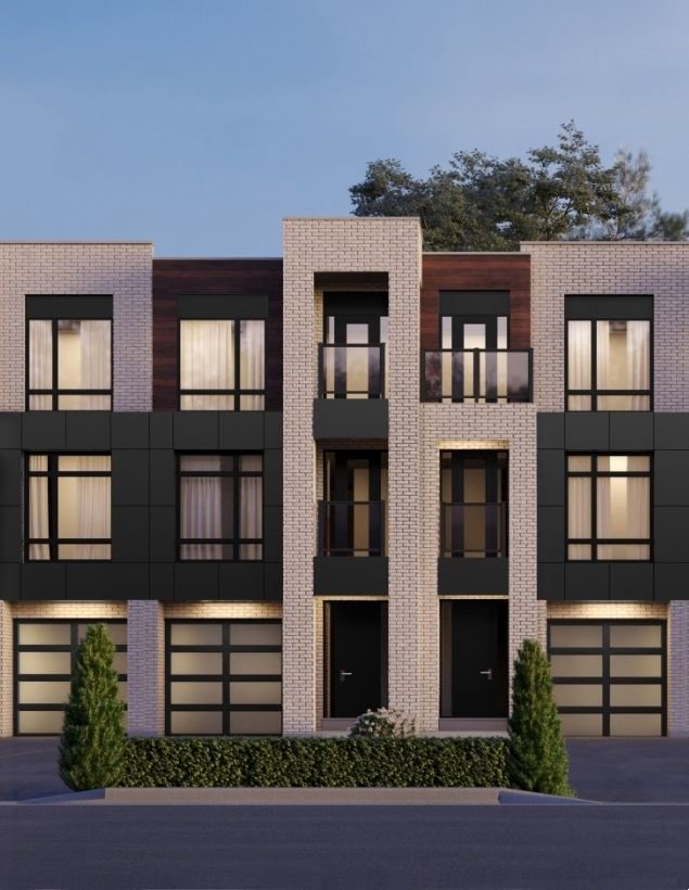 Nestled in the charming Ravine Towns, this modern three-story building with a flat roof showcases large windows and dark panels against light brickwork. Two entrances invite you in, flanked by small shrubs. A clear sky and partial trees complete the picturesque setting.