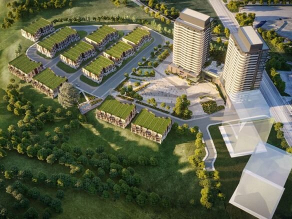 Aerial view of a modern residential complex, Ravine Towns, featuring two tall buildings and multiple low-rise structures with green roofs, surrounded by trees and greenery. Pathways and roads connect the development, situated near an open landscape reminiscent of a serene SXSW retreat.