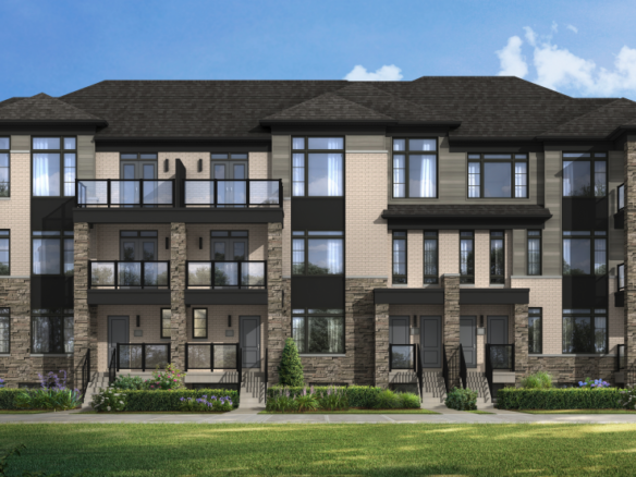 Discover new homes in Brampton with this modern, three-story residential building. It features beige and gray stonework, black trim, and multiple balconies. Nestled amidst lush greenery under a partly cloudy sky, it's an ideal setting for those seeking contemporary living.
