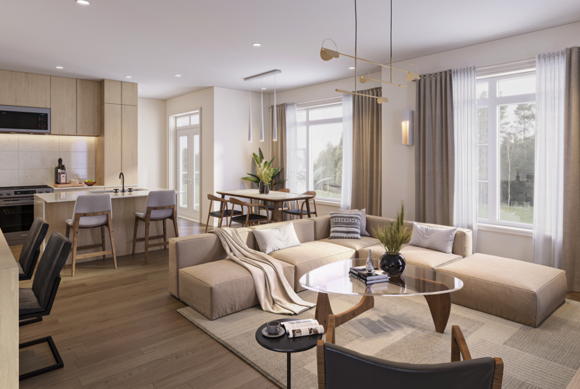 Explore this modern open-concept living room and kitchen area in new homes in Brampton, featuring light wooden flooring and neutral furnishings. A large sectional sofa complements the round glass coffee table, while natural light streams in through expansive windows with elegant curtains.