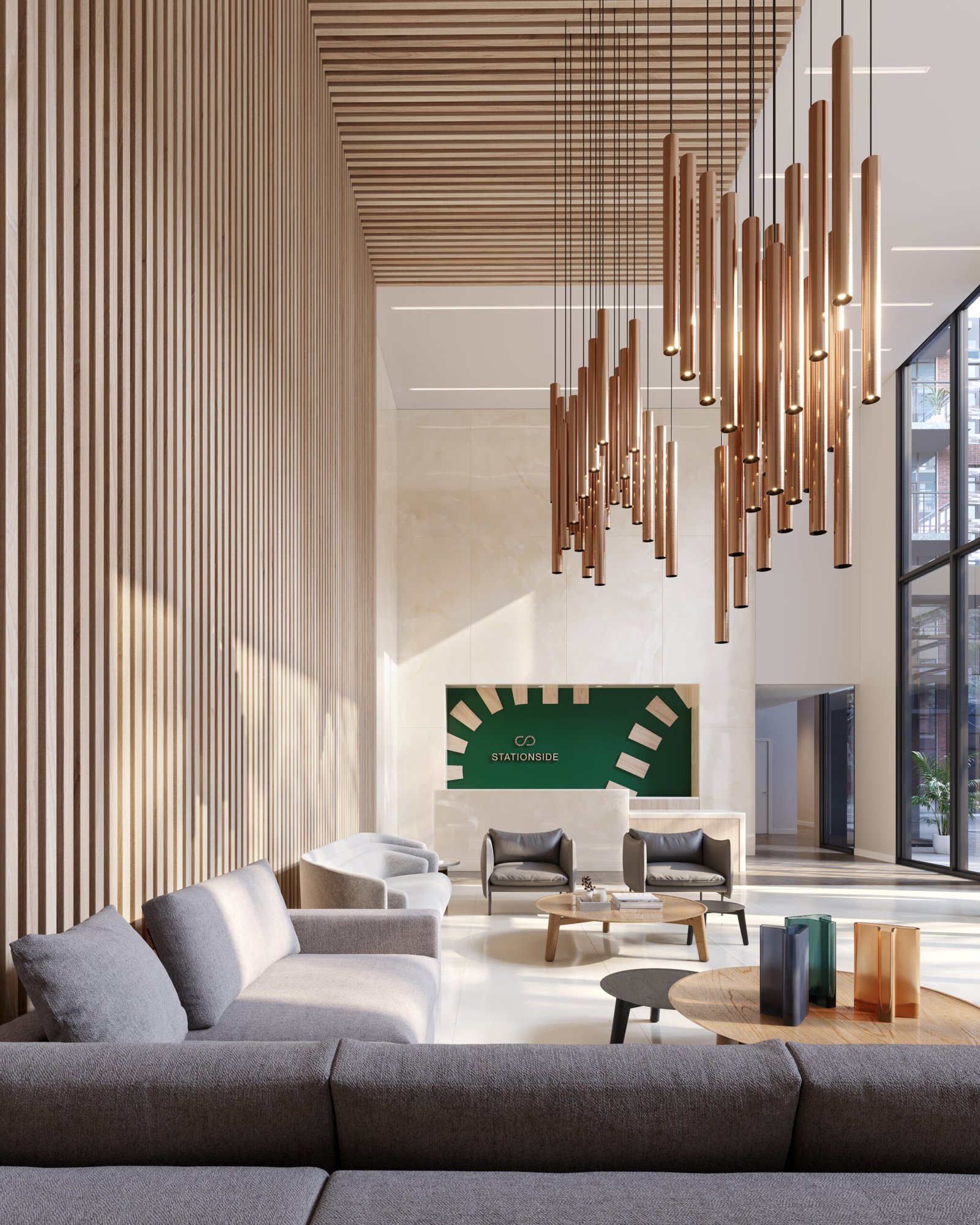 A modern lobby with wood paneling features a large hanging light fixture, gray couches, and a round wooden coffee table. A green sign with white graphics is on the far wall, and large windows flood the space with natural light—echoing the elegance of new condos in Brampton.