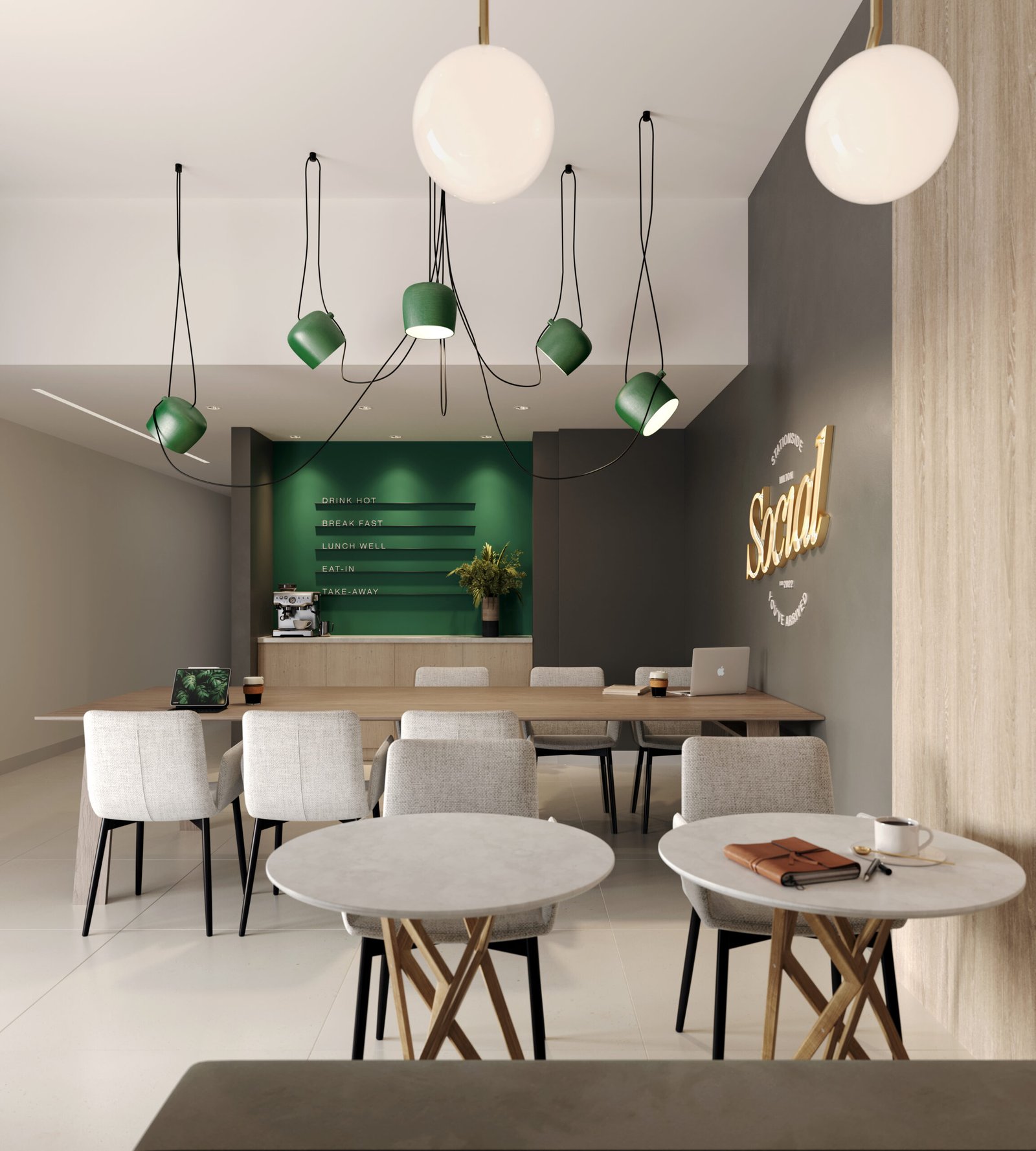 A modern cafe interior with round marble tables and light gray chairs. A green counter with menu items is at the back, beneath pendant lights. "Social" glows on the wall. A cup of coffee and laptop sit on one table, offering a cozy space to discuss new homes in Toronto or pre-construction homes nearby.