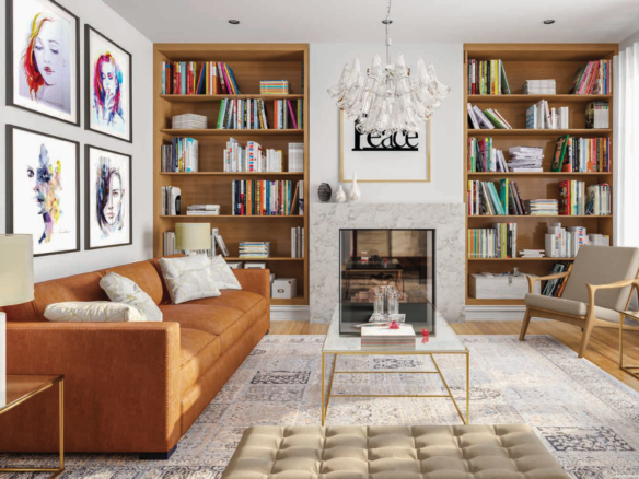 A stylish living room in one of the new homes features a brown leather sofa, two beige chairs, a glass coffee table, and a tufted ottoman. Bookshelves flank the fireplace, and framed artwork decorates the white walls. A chandelier hangs from the ceiling as large windows illuminate the space.