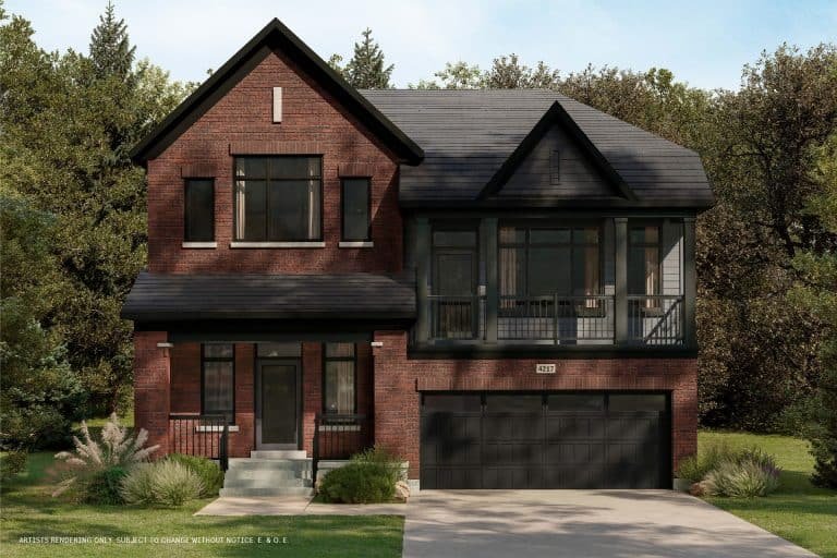 A modern two-story brick house with large windows and a double garage is nestled in a conservancy of lush greenery and trees. It boasts a small yard at the front, complemented by its peaked roof and inviting front porch with steps.