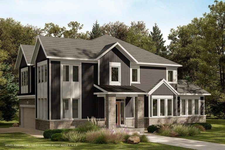 A modern two-story house with a dark gray exterior, large windows, and a combination of vertical and horizontal siding harmoniously blends with the surrounding conservancy of lush greenery and trees under a clear blue sky.