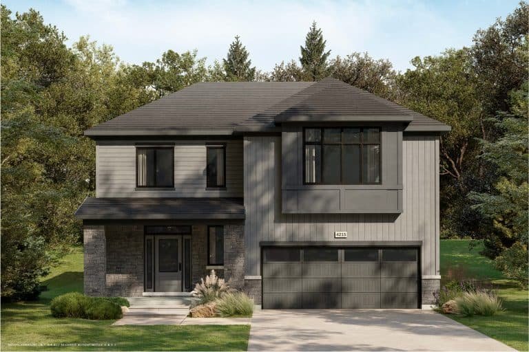 A modern two-story house with a dark gray exterior, large windows, and a double garage door stands elegantly amidst lush greenery. Surrounded by trees in a tranquil conservancy setting, it features a neatly manicured lawn in the front.