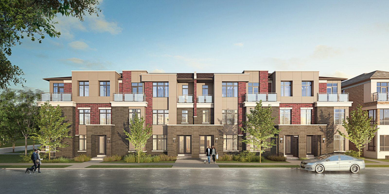 A modern townhouse complex with three stories features a mix of brick and beige panels, surrounded by green trees. A man walks a dog along the left sidewalk, while a couple stands near the entrance. A white car is parked on the street, highlighting these stylish new homes in Brampton.