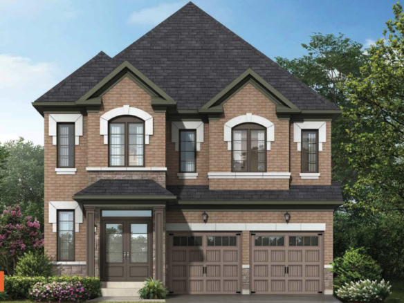 A two-story brick house in Brampton with a dark gray roof features a double garage with brown doors. The facade includes white trim around the windows and is surrounded by greenery and flowering shrubs, all under a clear blue sky. It's an appealing example amidst new homes in the area.