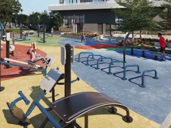 Outdoor fitness park with exercise equipment on colorful rubber flooring. People are using various workout stations surrounded by trees and flowers, creating a serene atmosphere. In the background, the sleek architecture of new homes in Brampton adds a modern touch to the landscape.