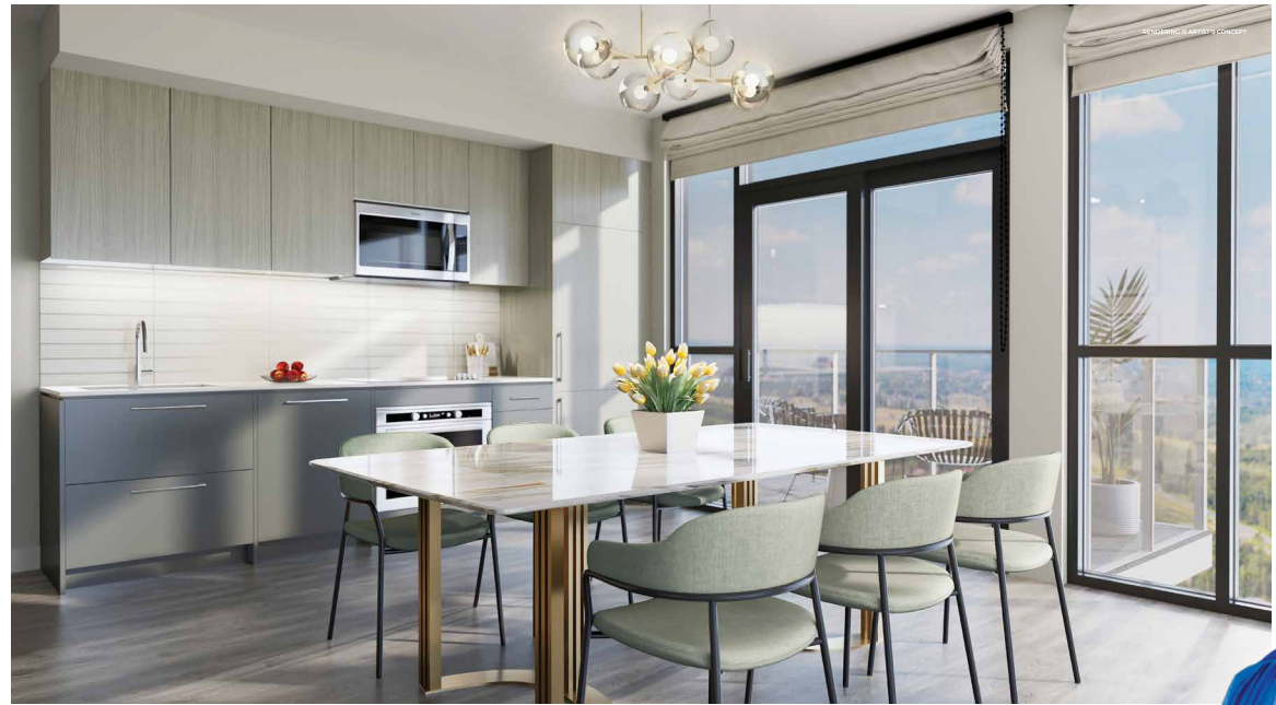 Modern kitchen and dining area in new homes feature light gray cabinets, a sleek white dining table, and pastel green chairs. Large floor-to-ceiling windows offer a scenic view. A decorative light fixture hangs above the table, with a vase of yellow tulips perfectly centered.