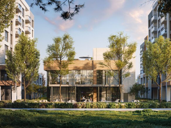 The modern, glass-fronted building, known as Mile & Creek Condos, is surrounded by lush trees and flanked by two towering residential structures. Set under a partly cloudy sky, grass and vibrant plants enhance the scenic foreground.
