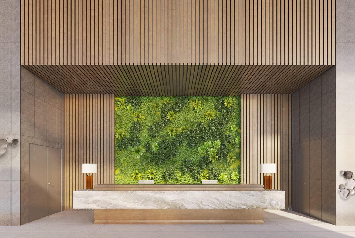 Experience the elegance of new homes with a modern lobby featuring a large green plant wall behind a marble reception desk. The architecture includes wooden panels and sculptures on gray walls, while two lamps with white shades add to the minimalist atmosphere.