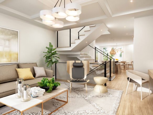 A modern living room features a beige sofa, cushions, and a decor-topped coffee table. A staircase ascends to the upper floor. With a plant, abstract art, wooden furniture, and dining area in the background, this bright space reflects the elegance of new condos in Brampton.