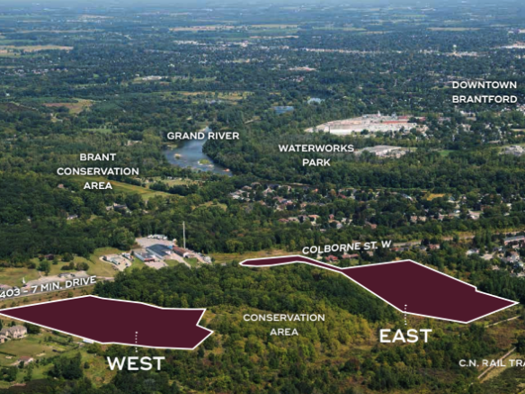 Aerial view of a landscape featuring two marked areas labeled "West" and "East" near Colborne St. W., with Sienna Woods adding natural charm. The Brant Conservation Area lies nearby, with roads, trees, and the Grand River visible. Downtown Brantford and neighboring towns can be seen in the distance.