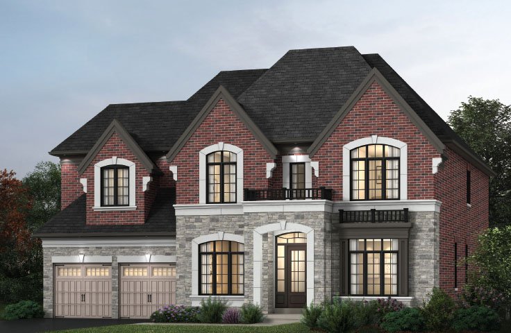A two-story brick and stone house by Sg Homes featuring a dark roof. It has arched windows, two garage doors on the left, and a small balcony on the upper right. The surrounding landscape includes bushes and trees, beautifully illuminated with outdoor lighting.