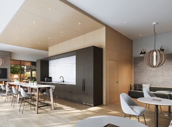 Modern open-concept room in new condos with a sleek kitchen featuring a dark island and light wooden cabinetry. Nearby, a dining table and chairs are arranged. Seating area includes sofas and round tables, with pendant lights adding warmth. Large windows allow natural light.