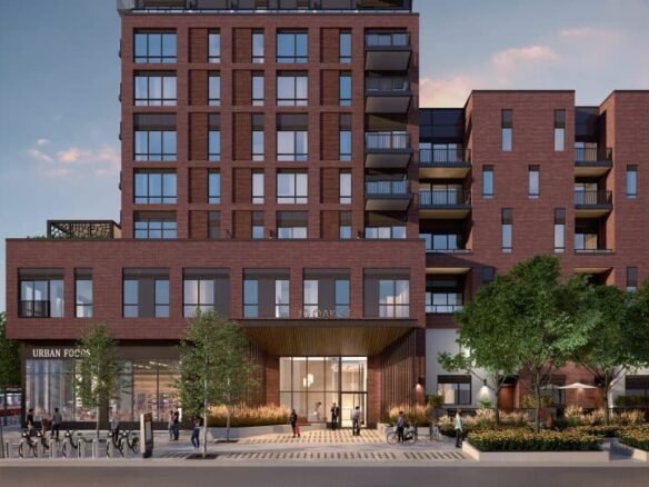 A modern, multi-story red brick building with balconies at various levels showcases the allure of pre-construction homes. Ground-floor shops and large windows invite passersby walking on the tree-lined sidewalk. The sky is clear with a soft pinkish hue, enhancing the charm of new homes in GTA.