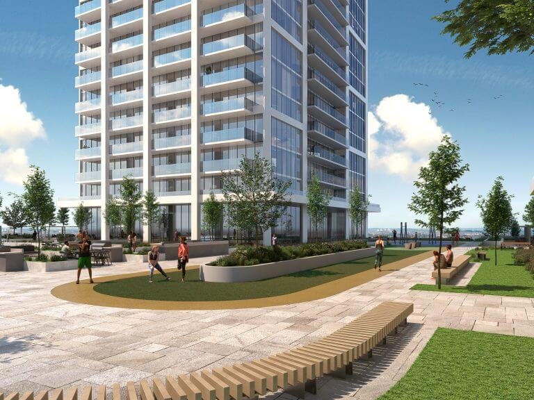 A modern high-rise, featuring sleek glass windows, stands beside a landscaped recreational area with a pathway, benches, and greenery—ideal for those scouting new condos. People leisurely enjoy the sunny open space while the sky remains clear with a few gentle clouds. A modern high-rise, featuring sleek glass windows, stands beside a landscaped recreational area with a pathway, benches, and greenery—ideal for those scouting new condos. People leisurely enjoy the sunny open space while the sky remains clear with a few gentle clouds.