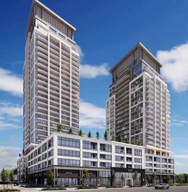 Two modern high-rise buildings with glass facades stand under a clear blue sky. These new condos share a podium featuring commercial spaces and rooftop greenery. In the foreground, an empty street and parking lot await future residents seeking new homes in the GTA.