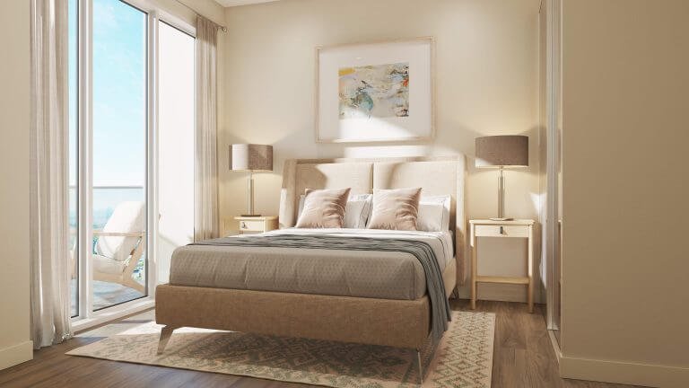 A cozy bedroom in one of the new condos features a beige bed, gray blanket, and two pillows. A large window with sheer curtains lets in natural light. Two matching lamps sit on bedside tables, and a painting hangs above the bed. A balcony with chairs is visible outside—Sg Homes living at its finest.