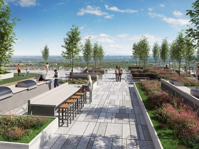 Sg Homes presents a rooftop terrace where people gather amidst lush trees and plants. Patrons enjoy tables and stools along a paved walkway, all while taking in the scenic view of the horizon and blue sky—your serene escape amidst stunning new homes in GTA.