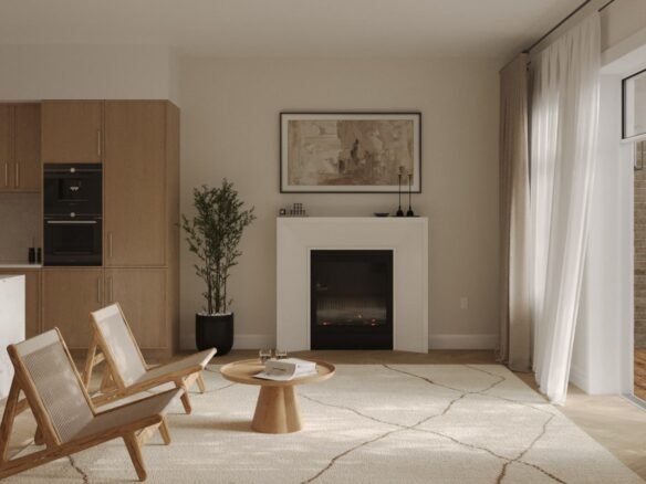 The minimalist living room in these new condos in GTA features two wooden chairs facing a round coffee table on a patterned rug. A central fireplace, adorned with art, adds charm, while natural light pours through sheer-curtained windows beside a potted plant.