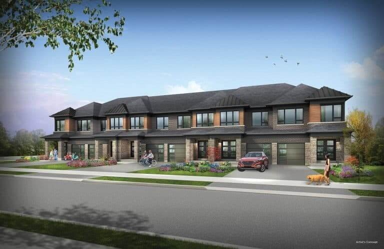 A row of modern townhouses by SG Homes showcases brown brick and dark roofs. A car is parked in front, people are out walking or biking, and someone walks a dog. Lush landscaping with flowers and trees lines the street under a clear blue sky.