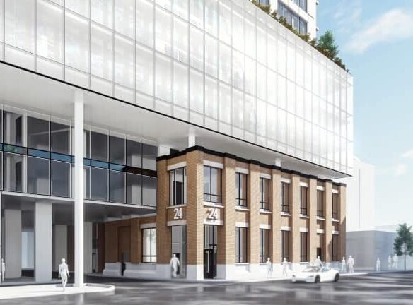 A modern architectural rendering of a building with a blend of glass and brick exterior. The lower floors feature brickwork with large numbers "24" visible, while the upper glass floors showcase the latest in pre-construction homes. Pedestrians and a car are on the street in front.
