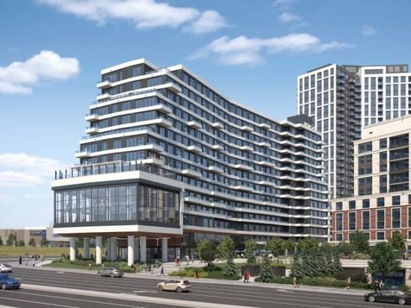 A modern multi-story building with a glass facade and unique wavy architectural design, part of the new condos in Sg Homes, is situated by a busy road. Several cars drive past while other tall buildings rise in the background under a blue sky with clouds.