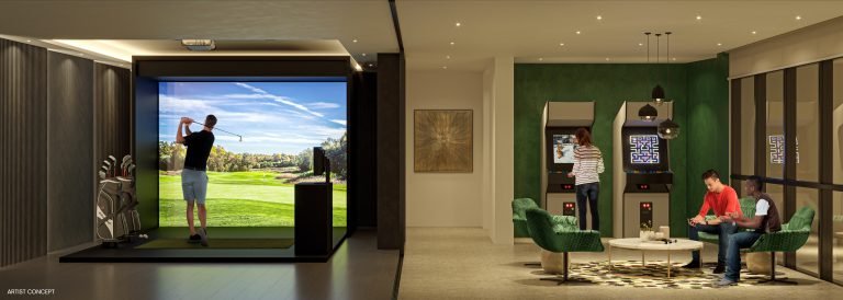 A modern indoor entertainment room in new GTA condos, featuring a golf simulator, two people playing on arcade machines, and two others seated around a table. The space is stylishly decorated with green chairs and framed artwork, offering a glimpse into the vibrant lifestyle of pre-construction homes.