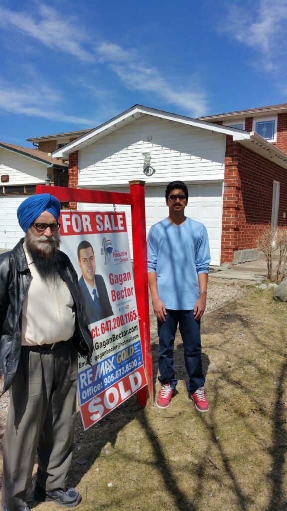 Two men standing in front of a house.