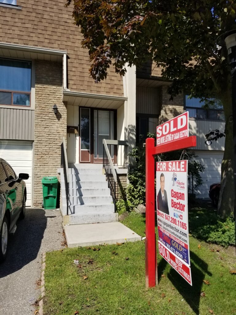 A house with a sold sign in front of it.