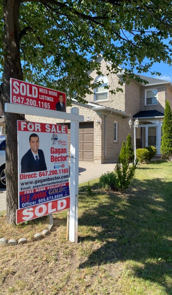 A house with a sold sign in front of it.