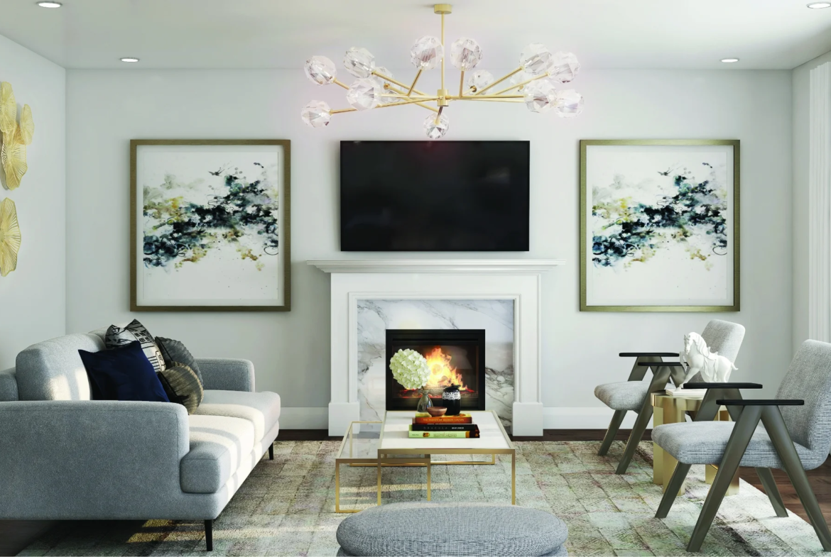 Modern living room at CALEDON CLUB featuring a gray sofa, armchairs, coffee table, and fireplace beneath a wall-mounted TV. Abstract art and gold decor frame the space, while a contemporary chandelier adds elegance overhead.