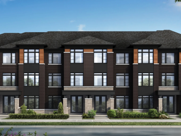 Modern three-story townhouse complex at Caledon Club with dark brick exterior, large windows, and landscaped greenery in front, set against a clear blue sky.
