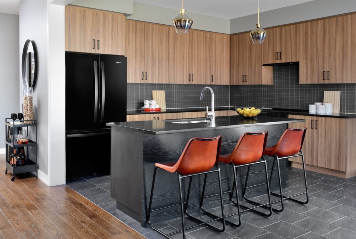 Contemporary kitchen with breakfast bar and custom cabinetry at Empire Avalon