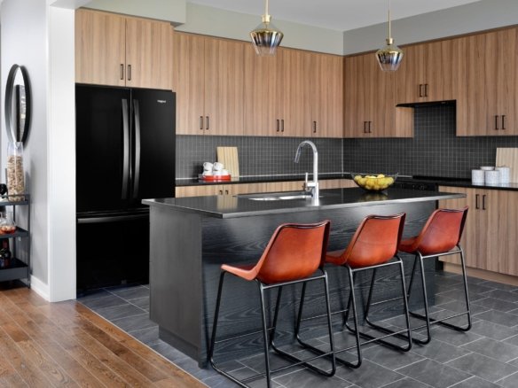 Contemporary kitchen with breakfast bar and custom cabinetry at Empire Avalon