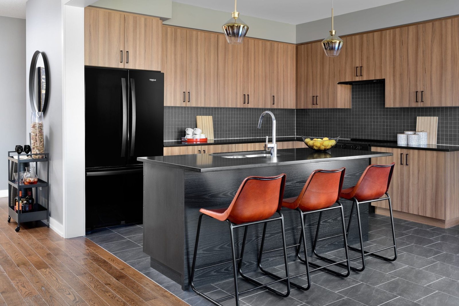 Contemporary kitchen with breakfast bar and custom cabinetry at Empire Avalon